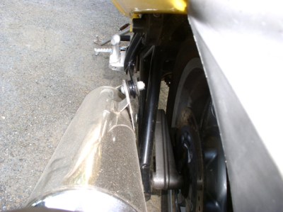 Mounting tab for the left muffler is bent inward