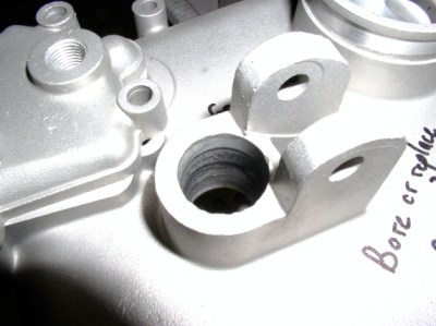 The clutch throwout bearing bore in the rear cover of the transmission is abnormally worn. 